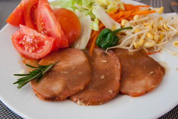 Roast of veal with sauce and salad