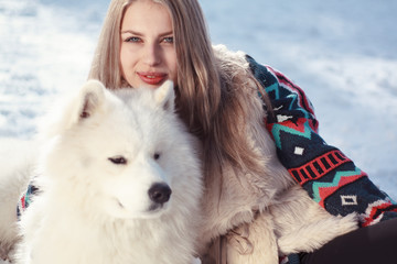 Young woman in winter park with dog