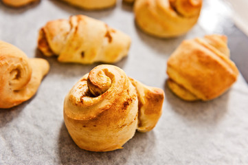freshly baked cinnamon scrolls on baking tray