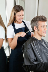 Hairstylist Giving Haircut To Client At Salon
