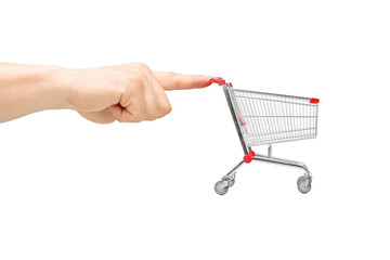 Fototapeta premium Finger pushing an empty shopping cart