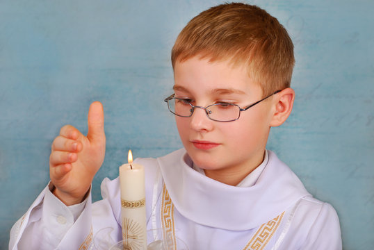 Boy Going To The First Holy Communion With A Candle