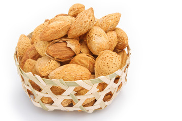 almond nuts in weaven basket on white