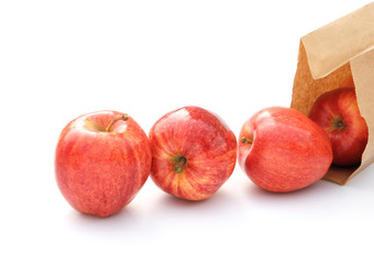 fresh apples and paper bag on white