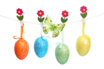Easter eggs hanging on a string - obrazy, fototapety, plakaty