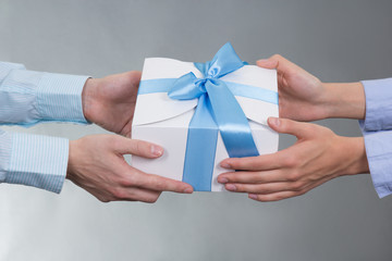 male and female hands with gift box
