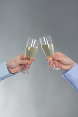 male and female hands with glass of champagne