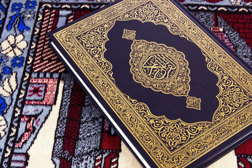 QUR'AN OVER MUSLIM PRAYER CARPET