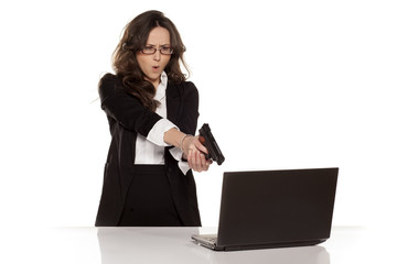 nervous and angry secretary destroys your laptop by using guns