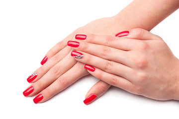 Beautiful female hand with red nails isolated on white
