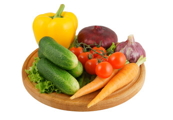 Vegetables on wooden cutting board isolated on white