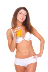 Beautiful athletic girl with a glass of orange juice