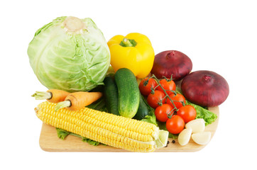 Vegetables on wooden cutting board isolated on white