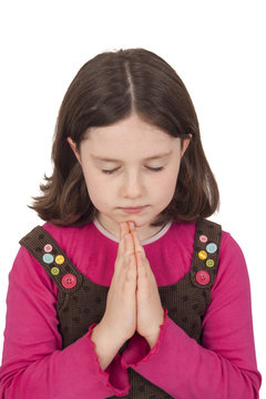 Beautiful girl praying with closed eyes