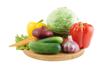 Vegetables on wooden cutting board isolated on white