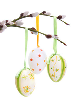 Colored easter eggs hanging from willow branches