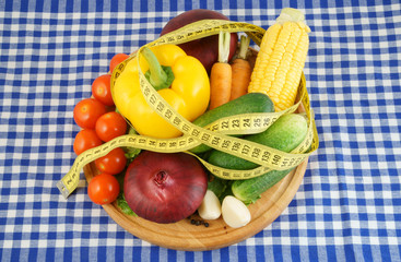 Vegetables with measuring tape, diet concept