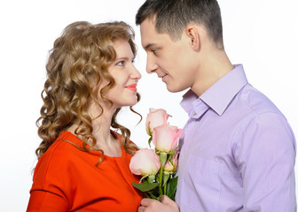 Closeup of young happy couple with pink roses