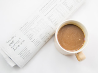 Morning coffee and a morning paper business news or newspaper