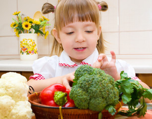 Portrait of a happy little girl with vegetables