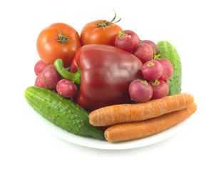 Many assorted vegetables on plate isolated over white