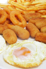 spanish combo platter with fried eggs, croquettes, calamares and