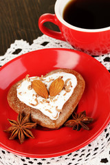 Chocolate cookie in form of heart with cup of coffee