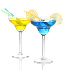 Yellow and blue cocktails in glasses isolated on white