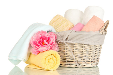 Fototapeta na wymiar Bathroom towels folded in wicker basket isolated on white