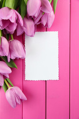 Beautiful bouquet of purple tulips and blank card