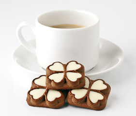 cup of coffee and chocolate cookies filled with heart-shaped and