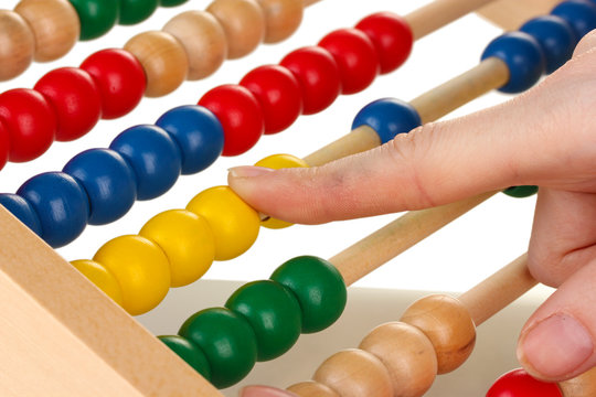 Accountant counting on abacus, close up