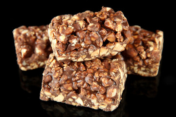 Chocolate sweets with nuts, isolated on black