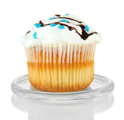 Cupcake on glass saucer, isolated on white