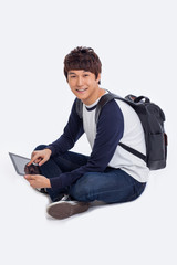 Young Asian student using pad PC