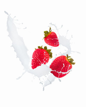 Strawberry in chocolate and mill splash over white background 