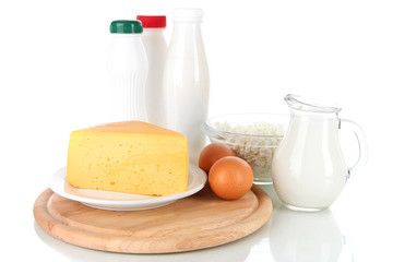 Dairy products and eggs on cutting board isolated on white