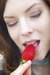 young beautiful woman with a strawberry