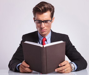 business man reading book at his desk
