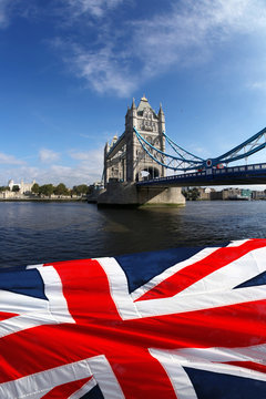 Tower Bridge with flag of England in London