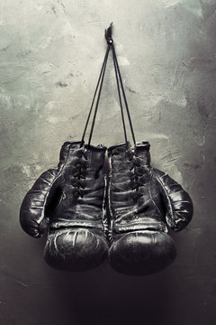 old boxing gloves hang on nail