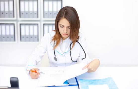 young female doctor doing some paperwork in hospital