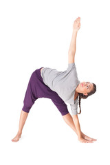 Young woman doing yoga exercise extended triangle pose