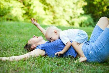 Mother and son having fun on the grass in park