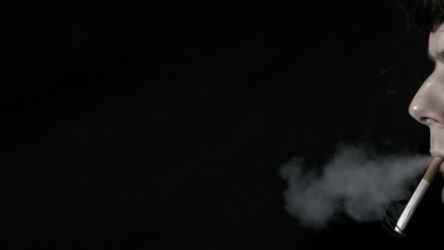 Man smoking cigarette and exhaling
