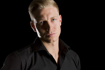 Obraz premium Low key portrait of charming man looking straight.