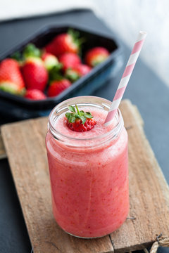 Fruit smoothie and strawberries