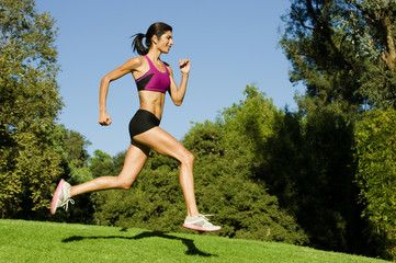Hispanic woman running in park