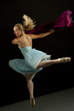 Caucasian ballet dancer in mid-air