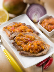 grilled steak with mango sauce, selective focus